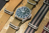 Five zulu straps are shown laying on top of a rock.